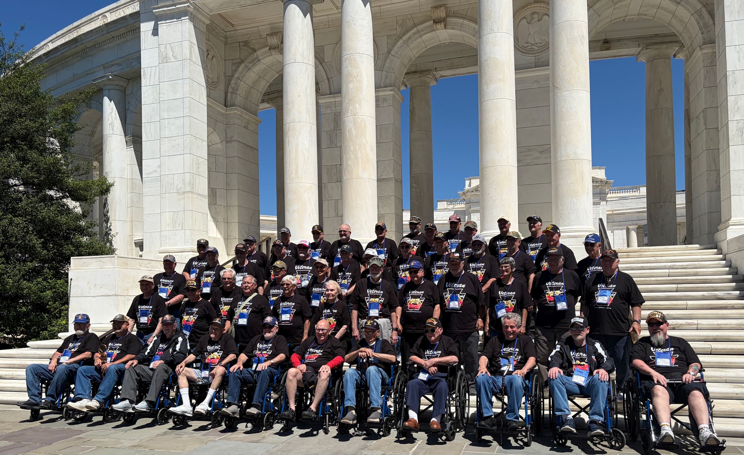 Honor Flight Pittsburgh Mission 17 veterans gathered on the steps of the Memorial Amphitheater at Arlington National Cemetery
